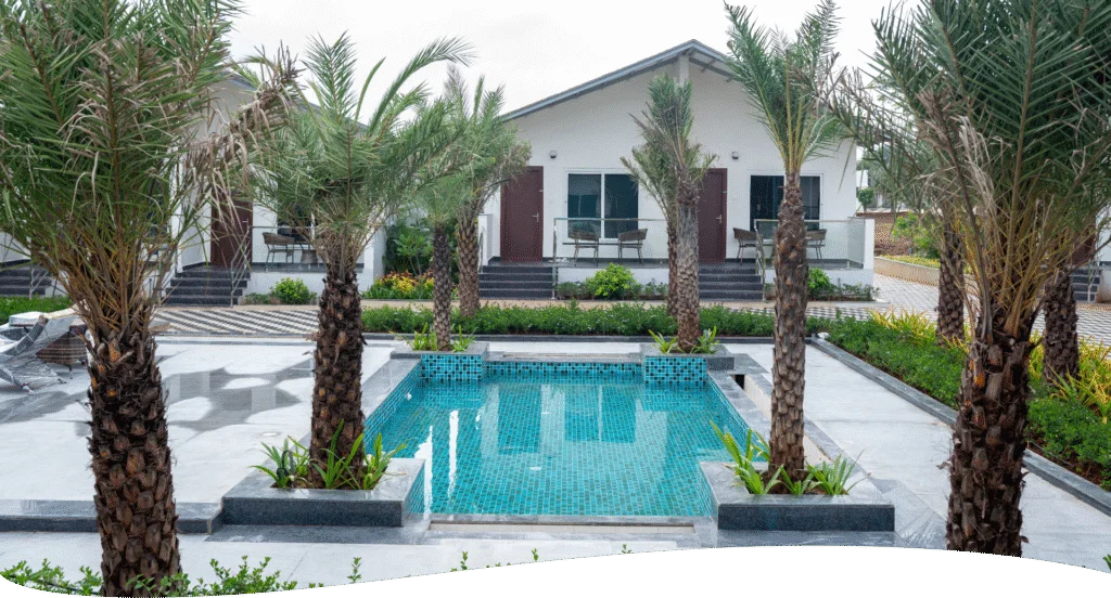 ALOHA Resorts — pool-facing room with pool view and palm trees