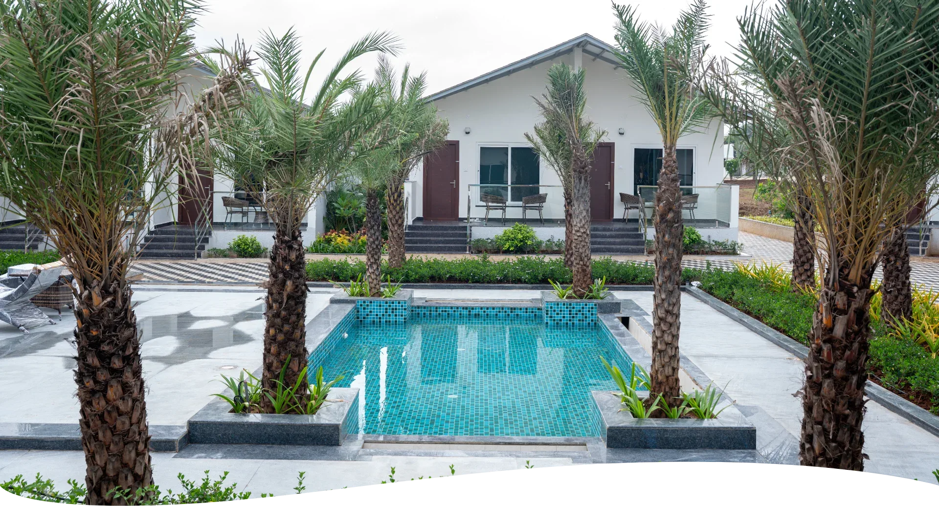 ALOHA Resorts — pool-facing room with pool view and palm trees